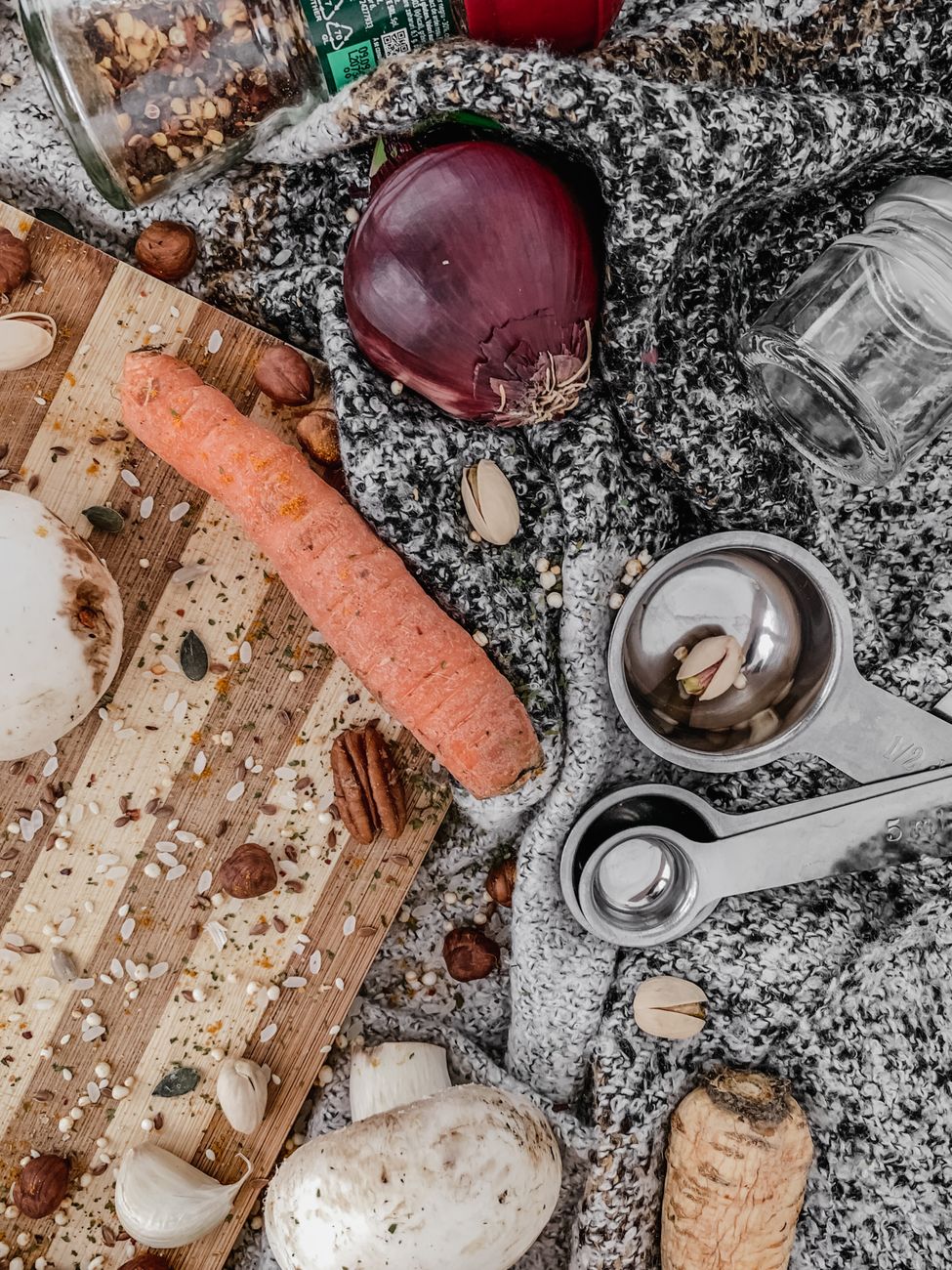 A cozy flat lay of fresh vegetables with measuring tools and spices, ideal for cooking themes.
