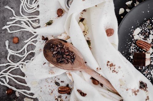 Brown Wooden Spoon on White Textile