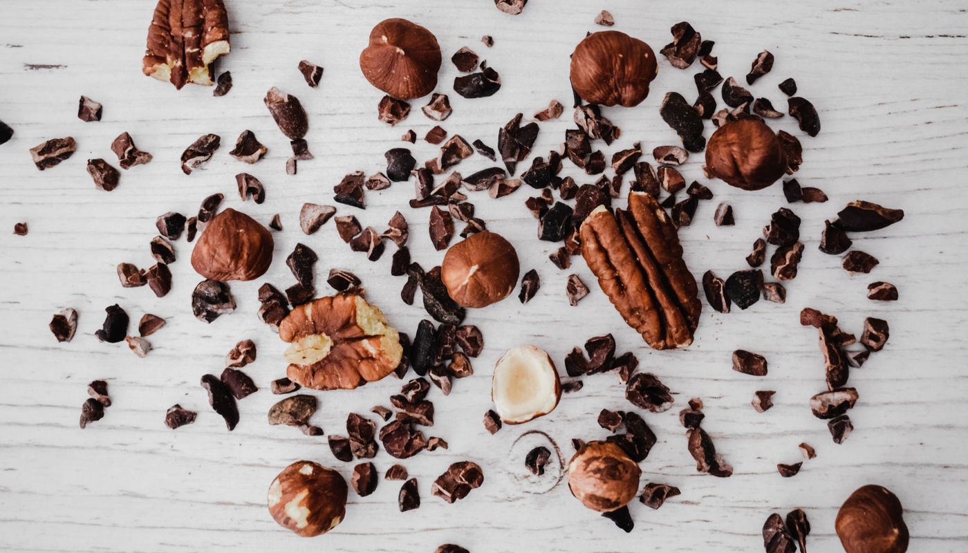 healthy mango dessert — Brown Crushed Nuts on White Wooden Table · Free. Photo: Pexels
