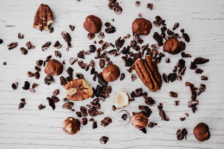 Brown Crushed Nuts On White Wooden Table