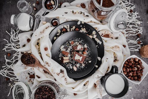 Messy Dessert Table with Ceramic Plates and White Textile