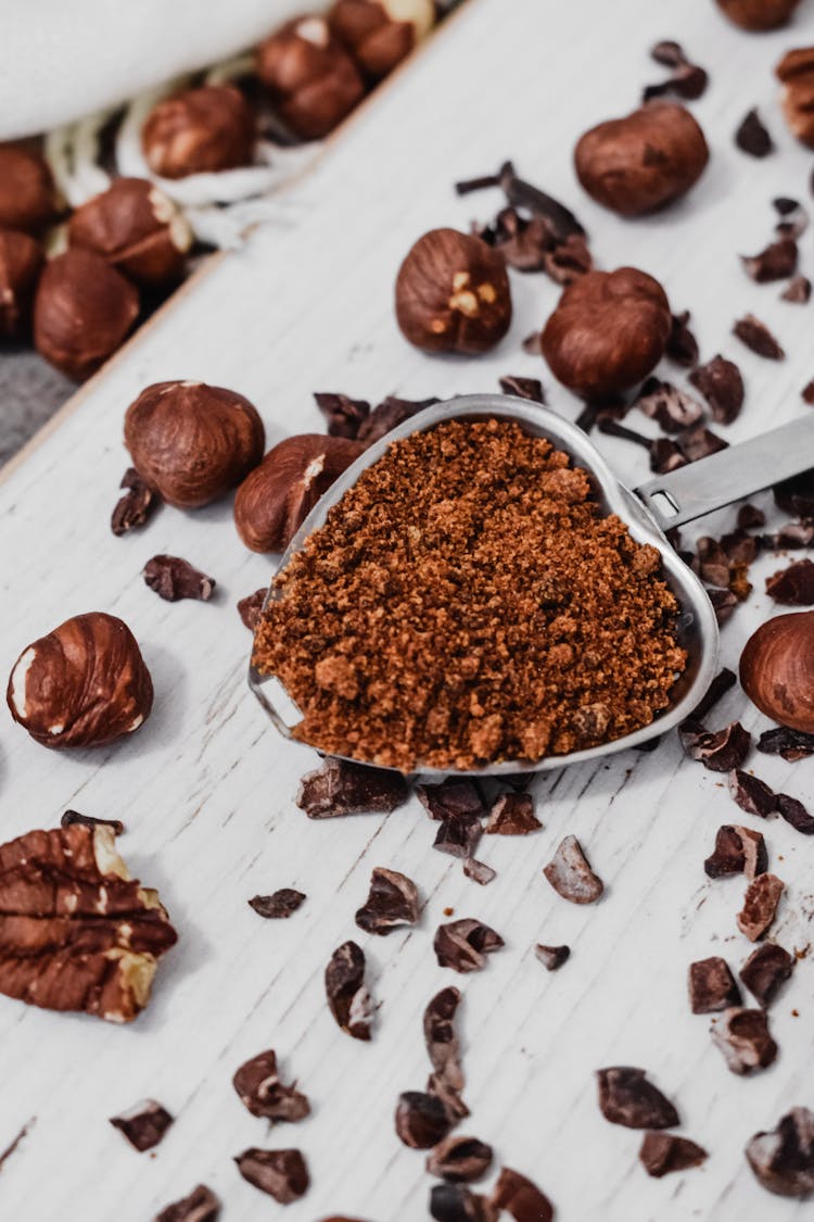 Crushed Hazelnuts On A Stainless Measuring Spoon