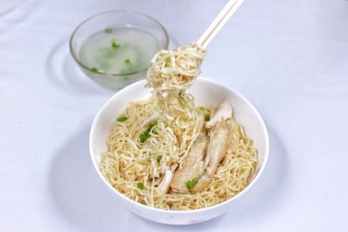 Free Tasty Indonesian chicken noodle dish with broth, showcasing vibrant flavors and textures. Stock Photo