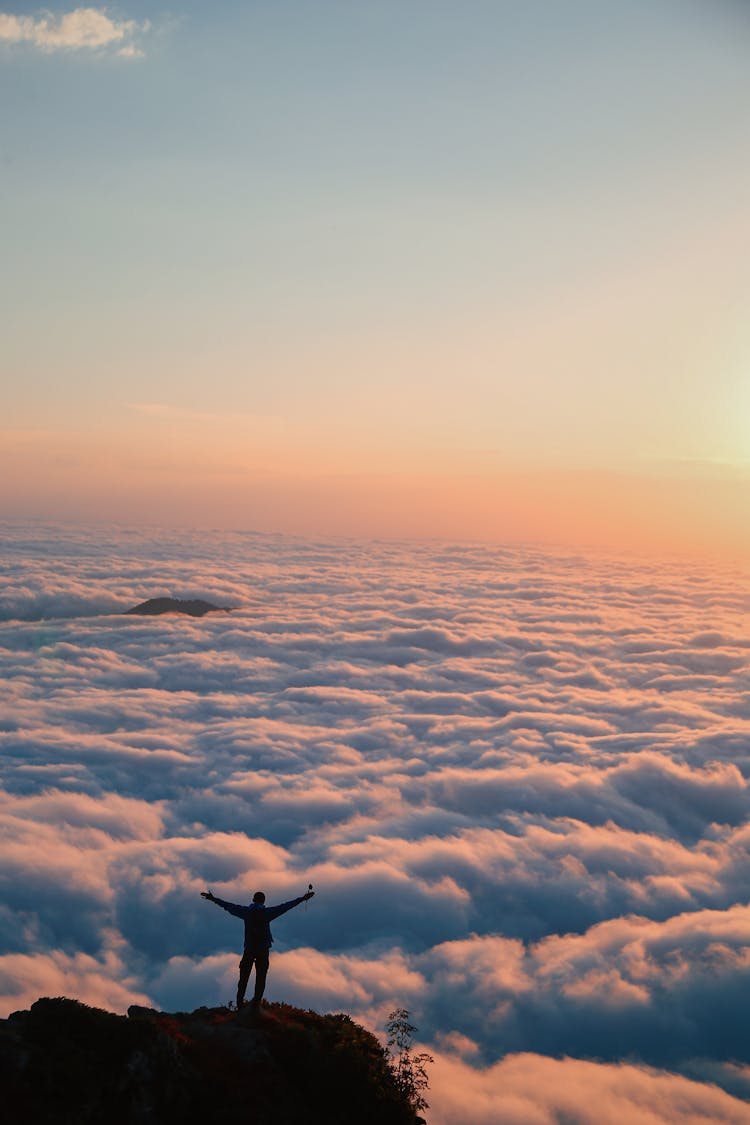 Unrecognizable Person With Outstretched Arms On Hill