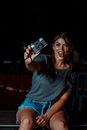Woman in Black Crew Neck T-shirt Holding Camera