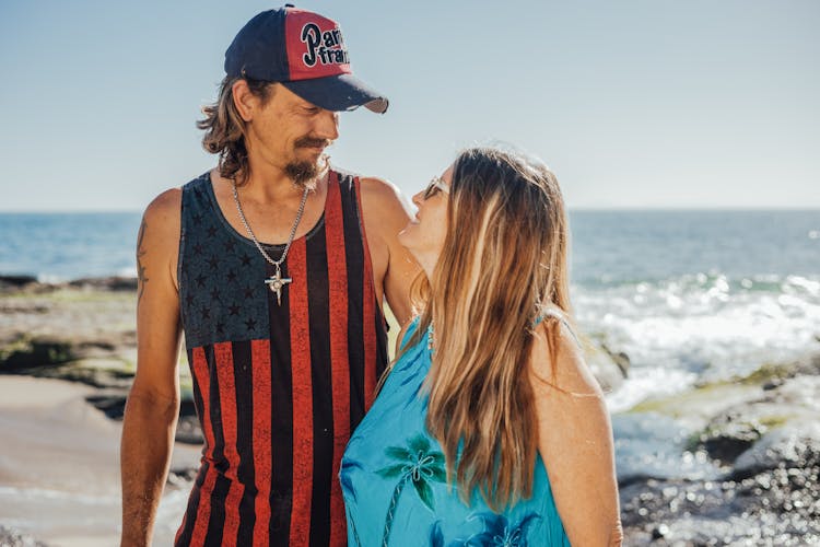 Man And Woman Standing On Beach