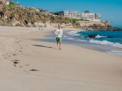 Girl in Pink Shirt and Pink Shorts Standing on Beach Shore
