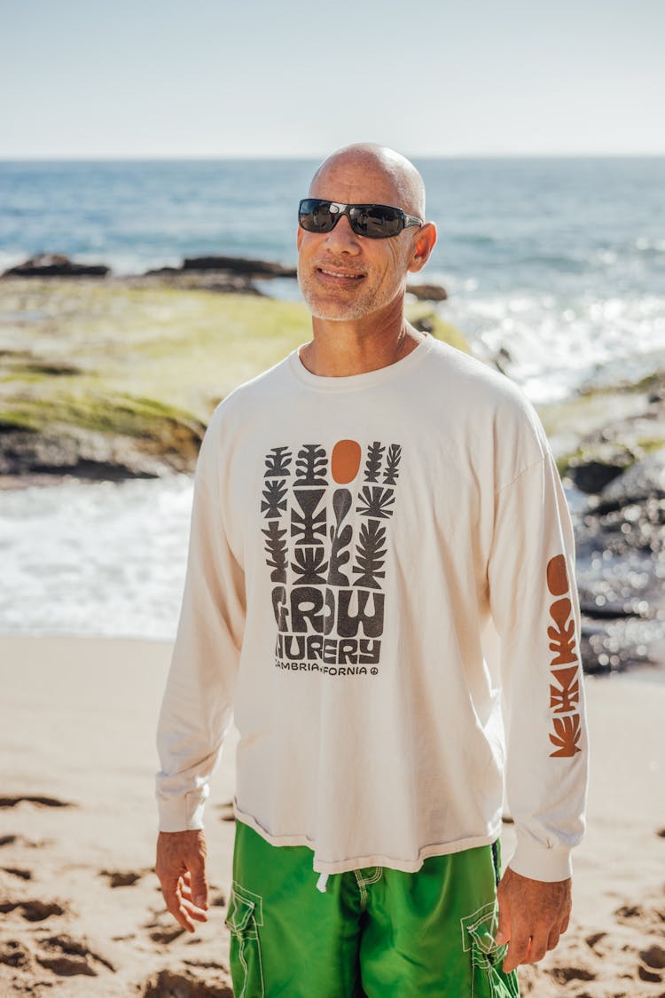 An Elderly Man In White Sweatshirt Smiling While Wearing Sunglasses