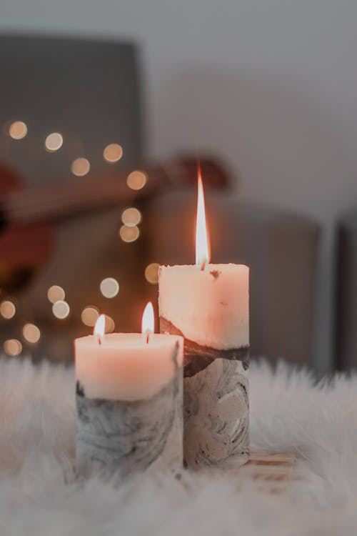 Free White Candles on White Fur Rug Stock Photo