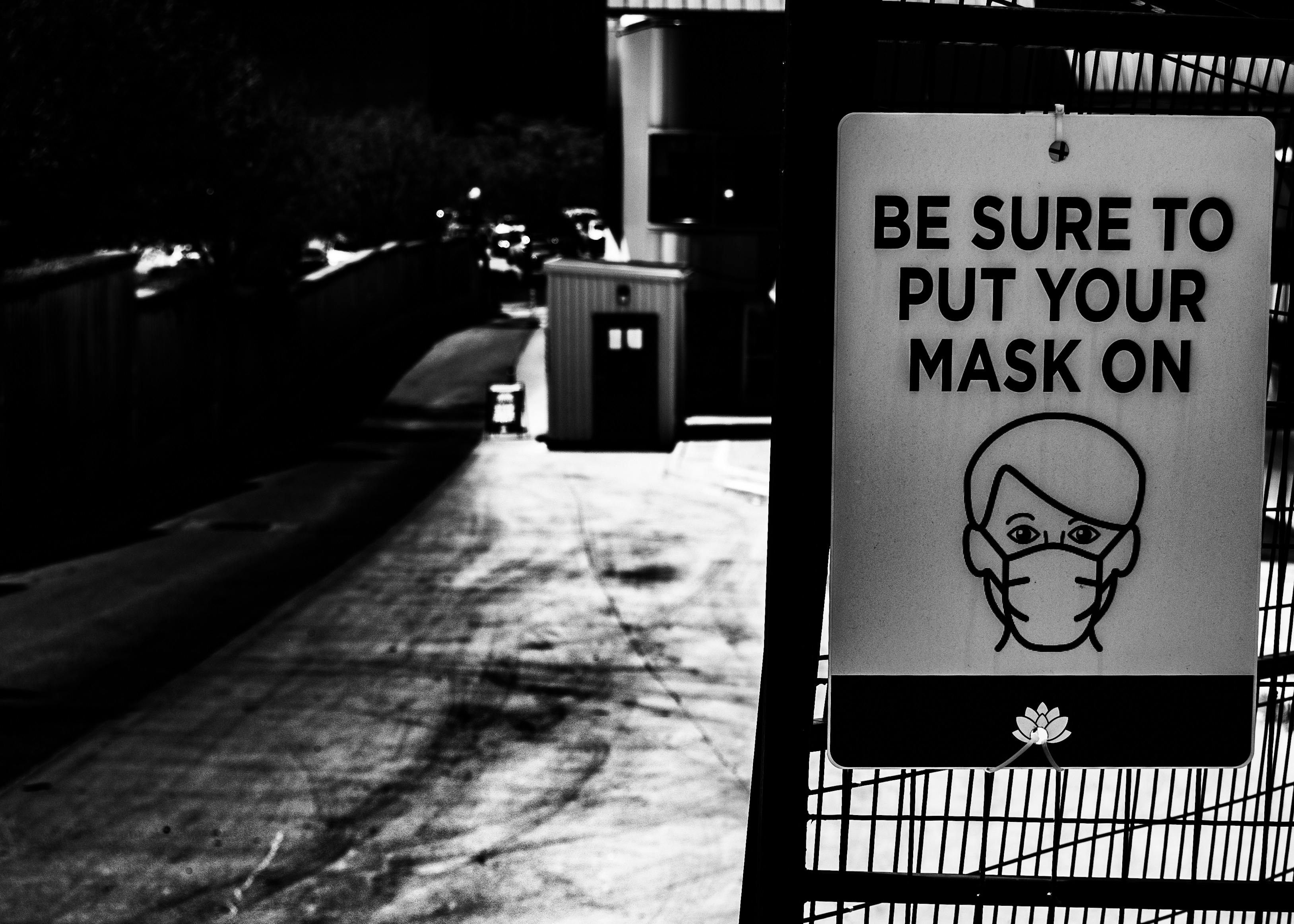 A glass of red wine next to a prescription pill bottle with a clear warning label.