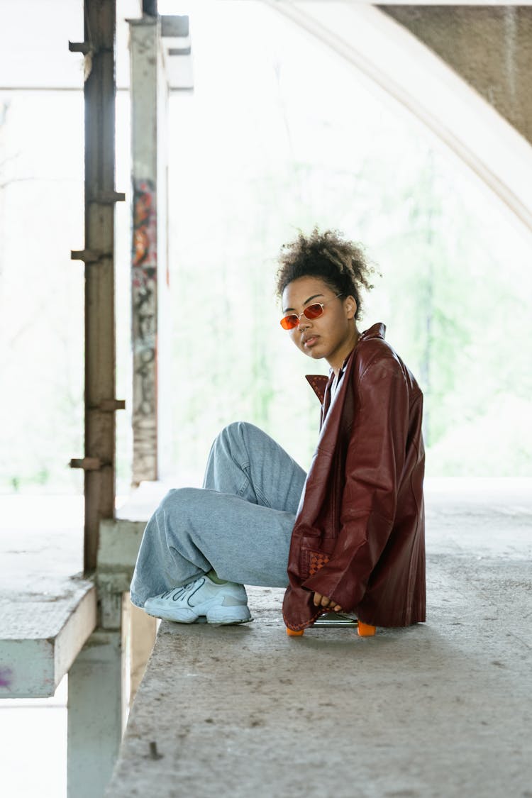 Woman In Brown Leather Jacket Wearing Sunglasses