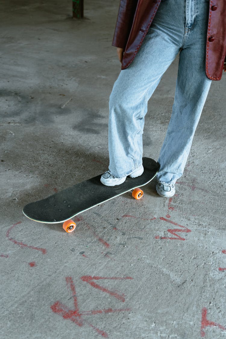 A Person Stepping On Skateboard 