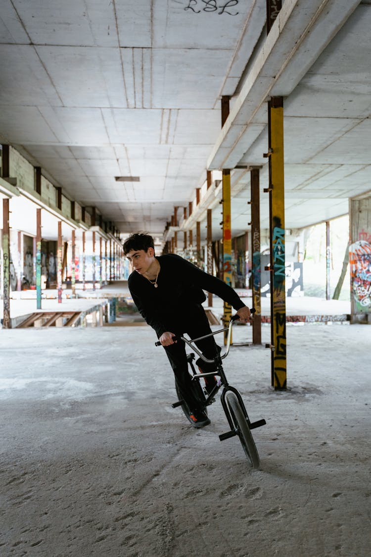 Young Man Riding A Bicycle