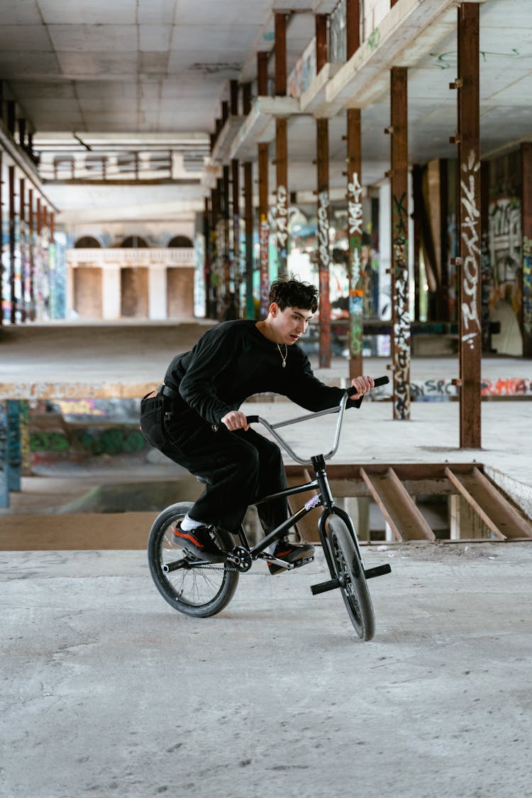 Man In Black Long Sleeve Shirt Riding On A Bicycle