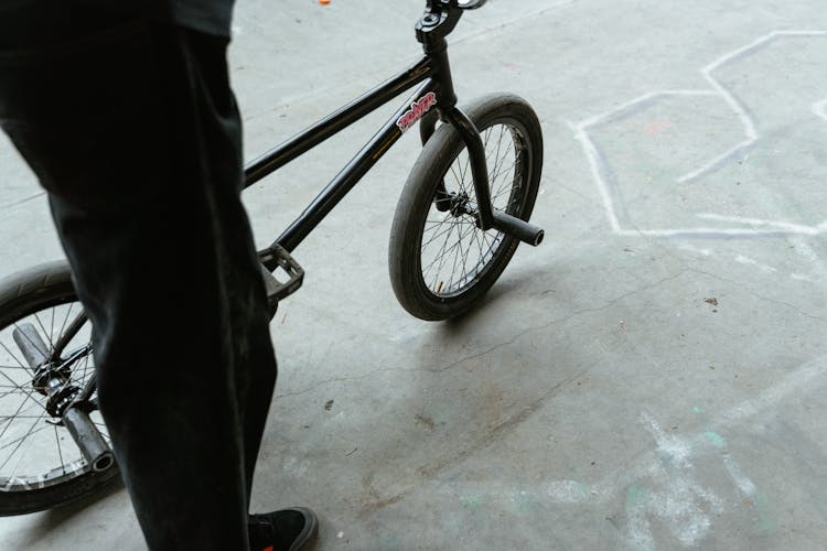 A Person Standing Beside The BMX Bicycle 