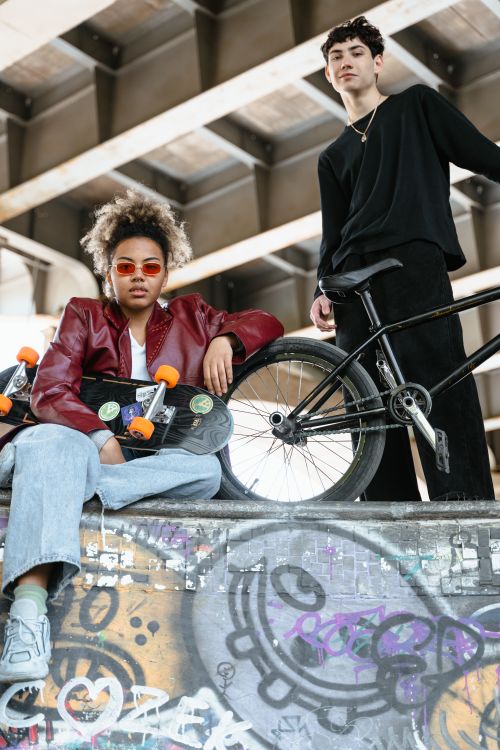 Free Two young skateboarders with vibrant style and attitude in an urban skate park setting. Stock Photo