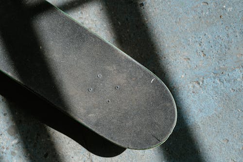 Skateboard on Concrete Ground Photo