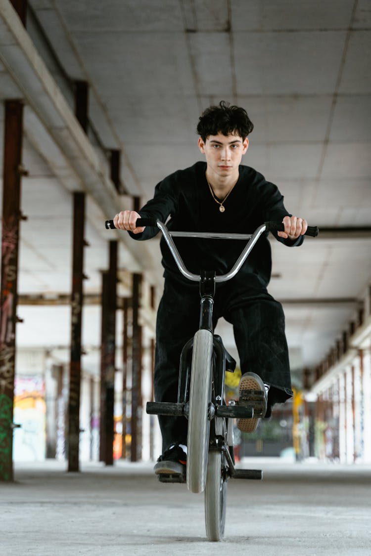 Young Man Riding A Bicycle