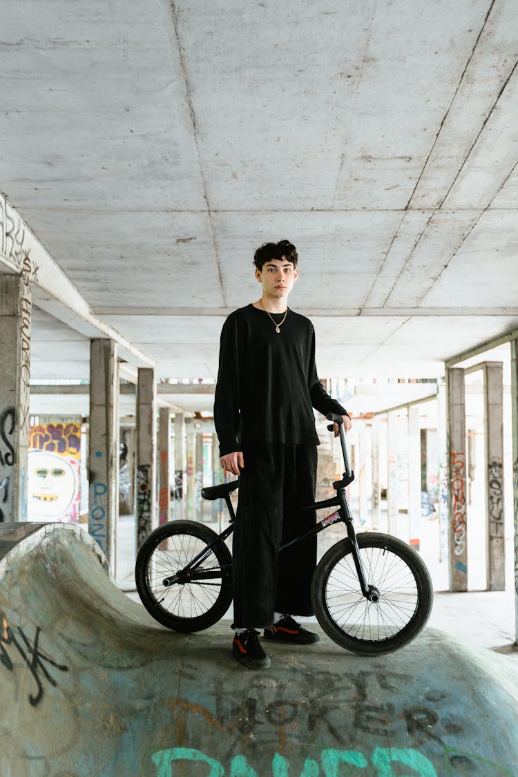 Man With A Bike Standing On A Ramp