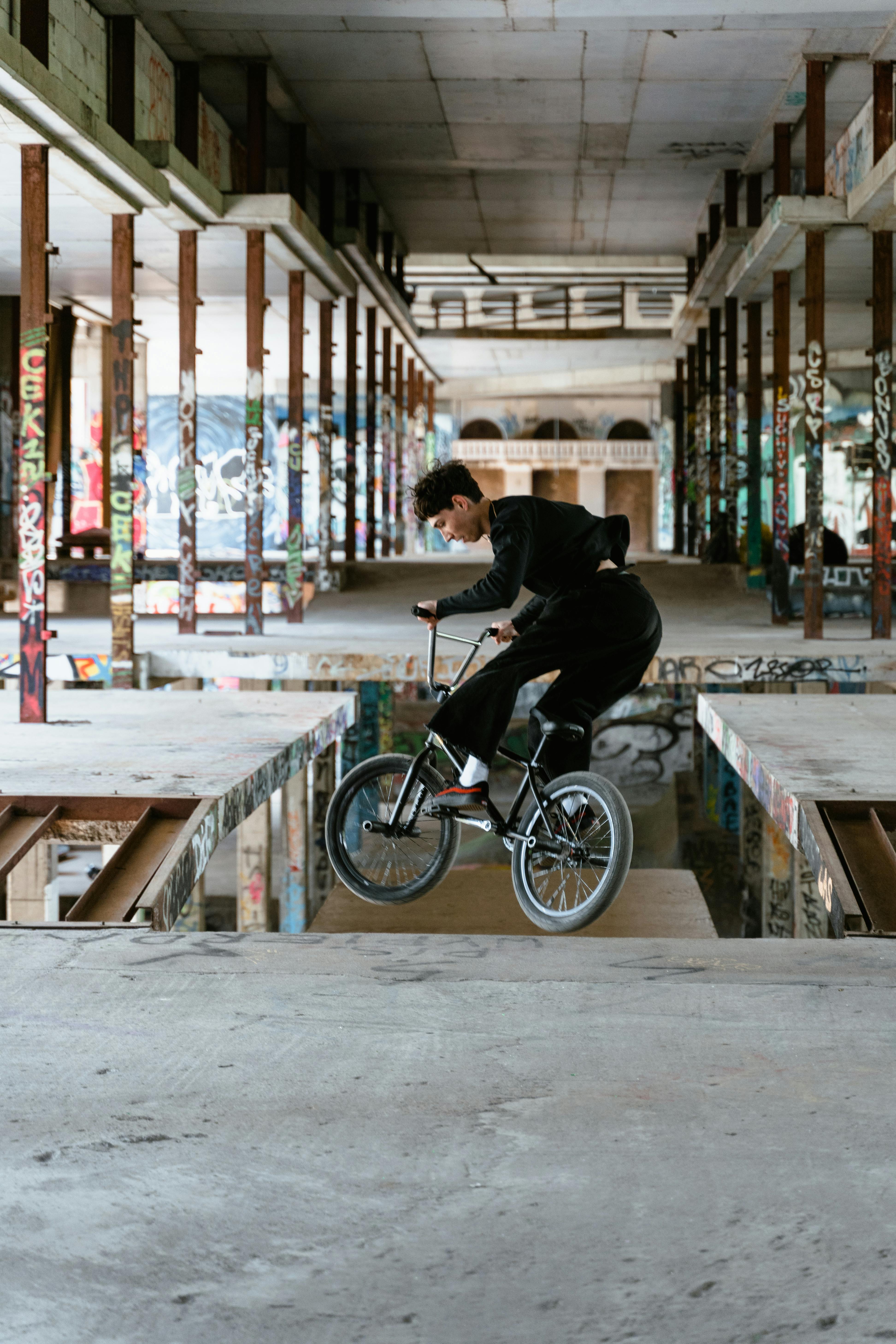 man in black long sleeves jumping a bike