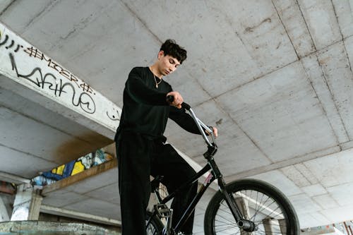 Man Riding a Bike Inside a Building