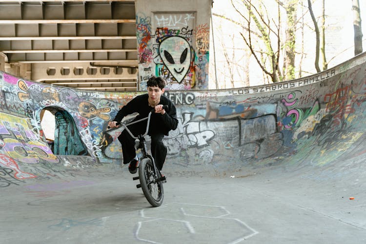 Man Riding His Bike On A Skate Ramp