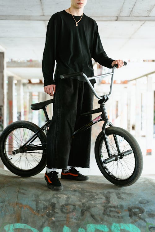 Free A Man in Black Sweater Riding a Bike Stock Photo