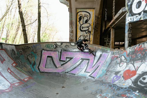 A Man Riding a Bicycle on Skate Park