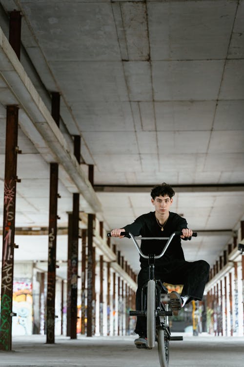 Free Man Riding a Bike Doing a Wheelie Trick Stock Photo
