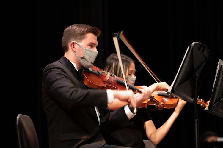 A Man And Woman Playing Violin