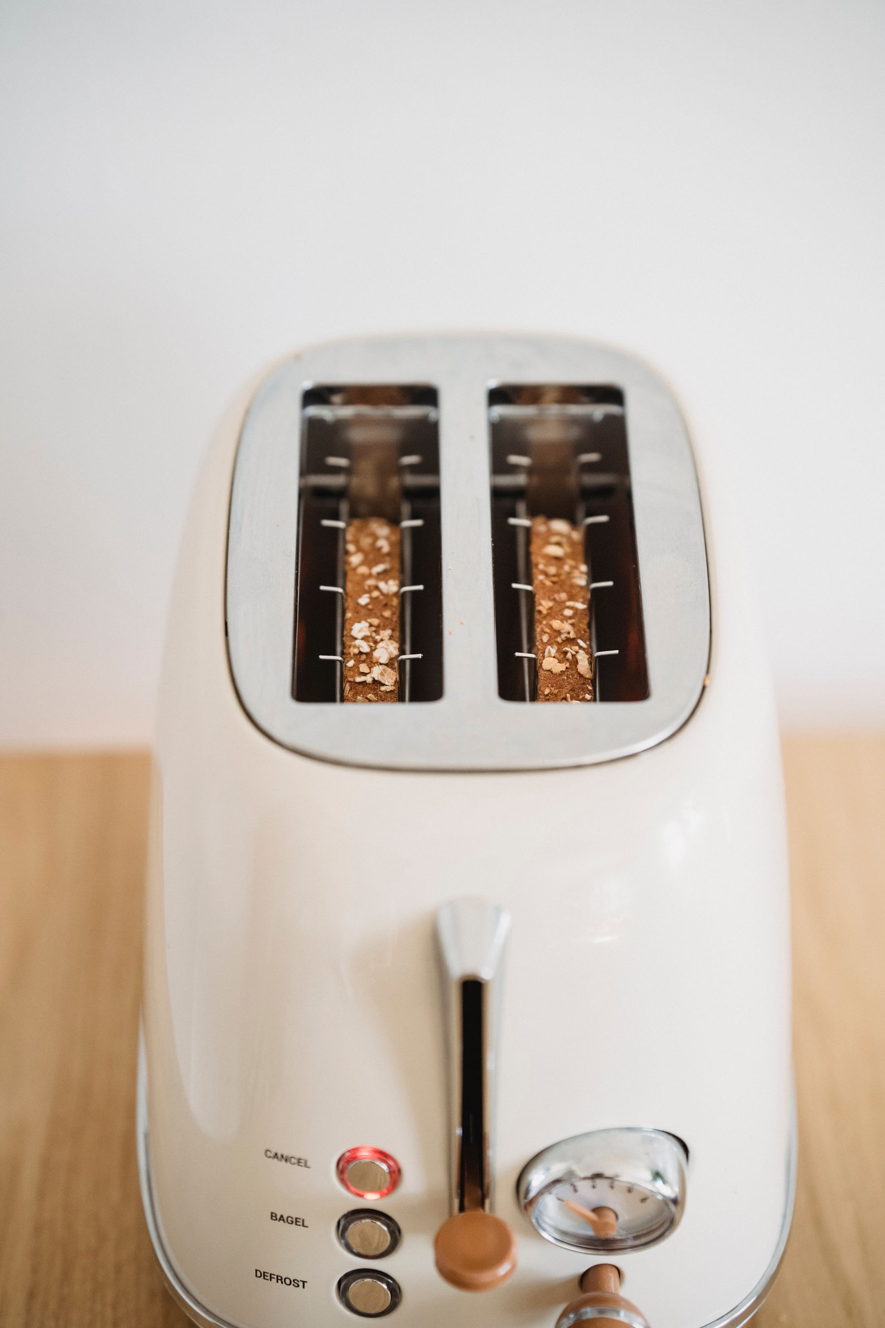 Simple toaster on a clear kitchen counter with strong visual contrast
