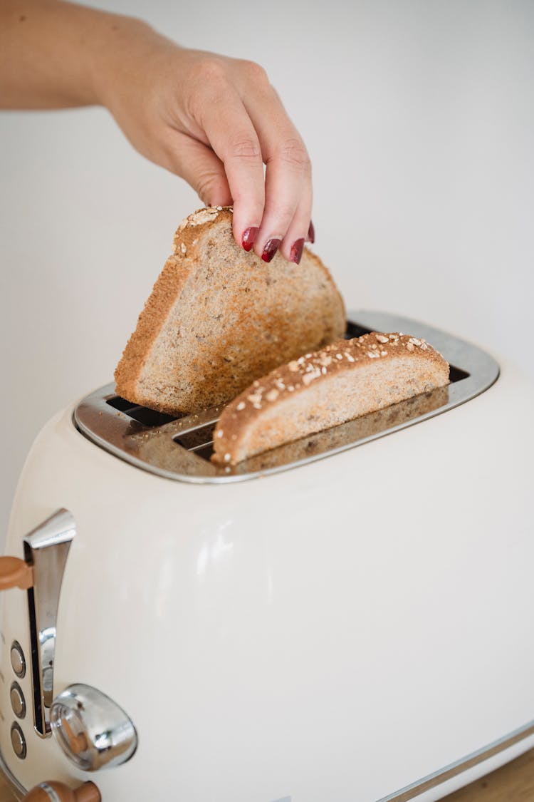 Putting Bread To Toaster