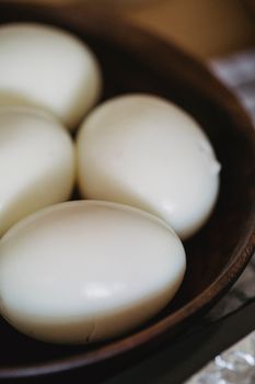 White Egg on Brown Wooden Bowl