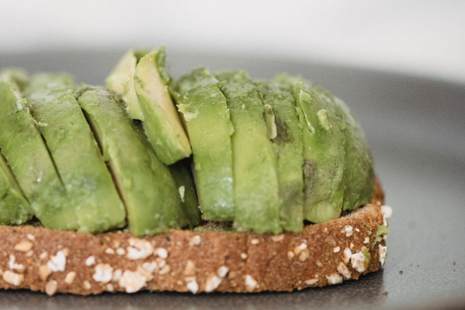 Close-up of freshly sliced avocado on a piece of whole grain bread, perfect for a healthy breakfast.