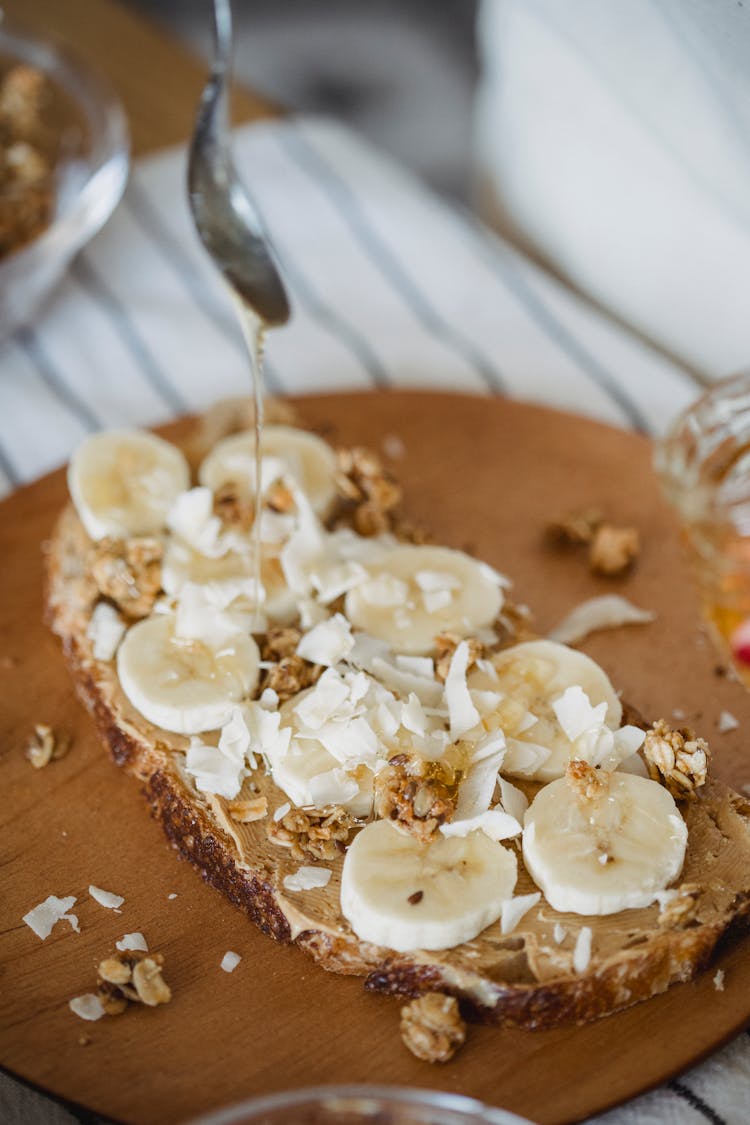 Spoon With Syrup Over Bread With Bananas