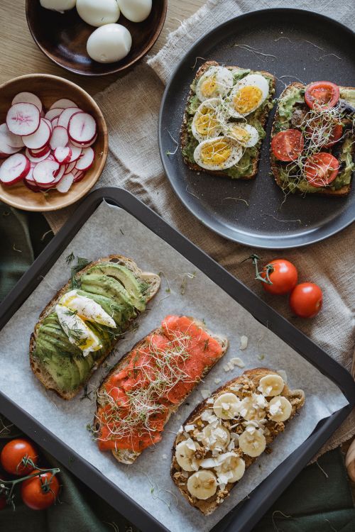 Free A variety of delicious and nutritious open-faced sandwiches with fresh toppings served in a cozy setting. Stock Photo