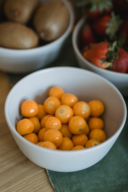 Close-up of a Bowl with Yellow Cherries, Strawberries and Kiwis 