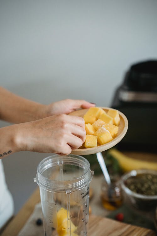 Person Holding Yellow Cubed Food