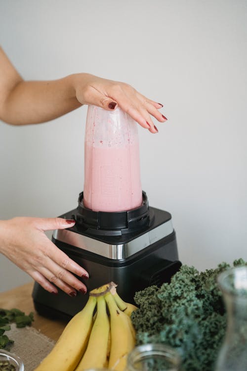 Free  A Person Making Strawberry Smoothie Using Blender Stock Photo