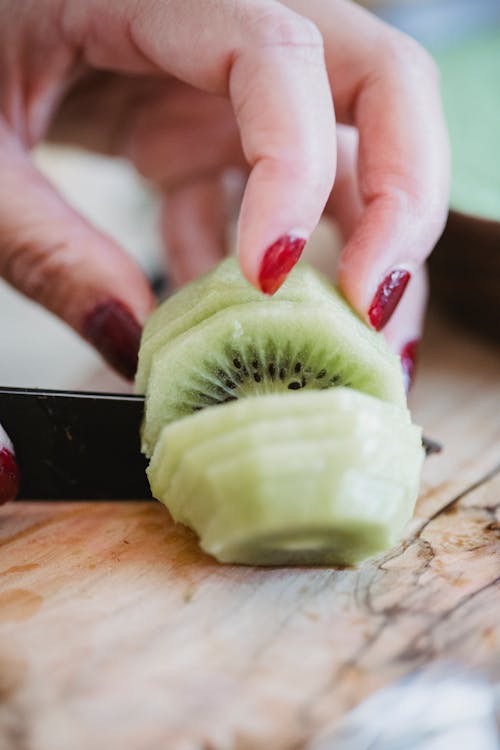 A Person Slicing a Fruit