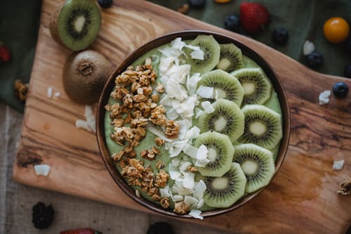 A Mouthwatering Kiwi Smoothie on a Wooden Surface