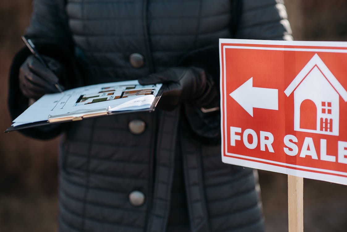 Free Man In Black Jacket Holding Red And White No Smoking Sign Stock Photo