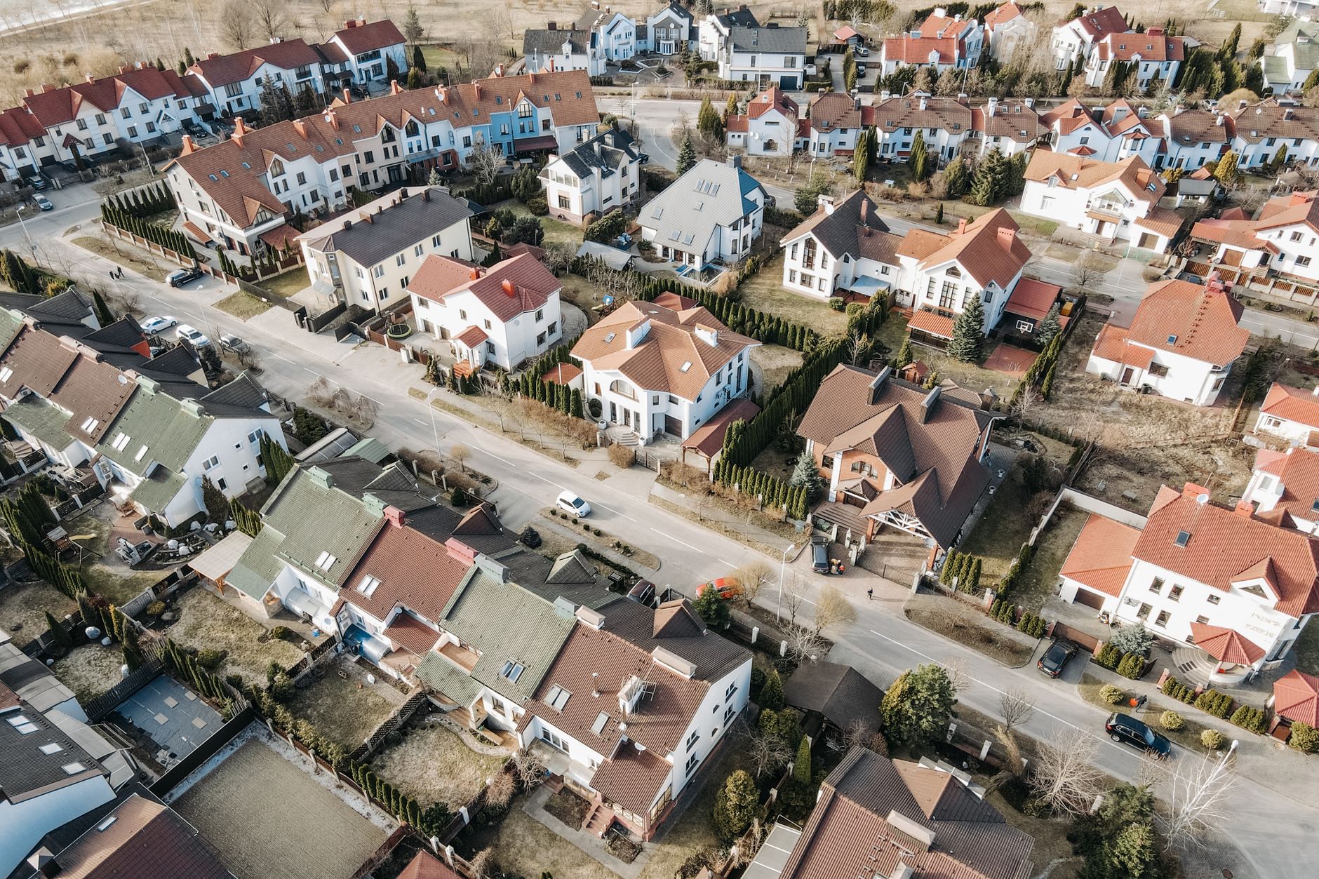 Drone view of an Australian suburb of detached houses with tiled roofs.