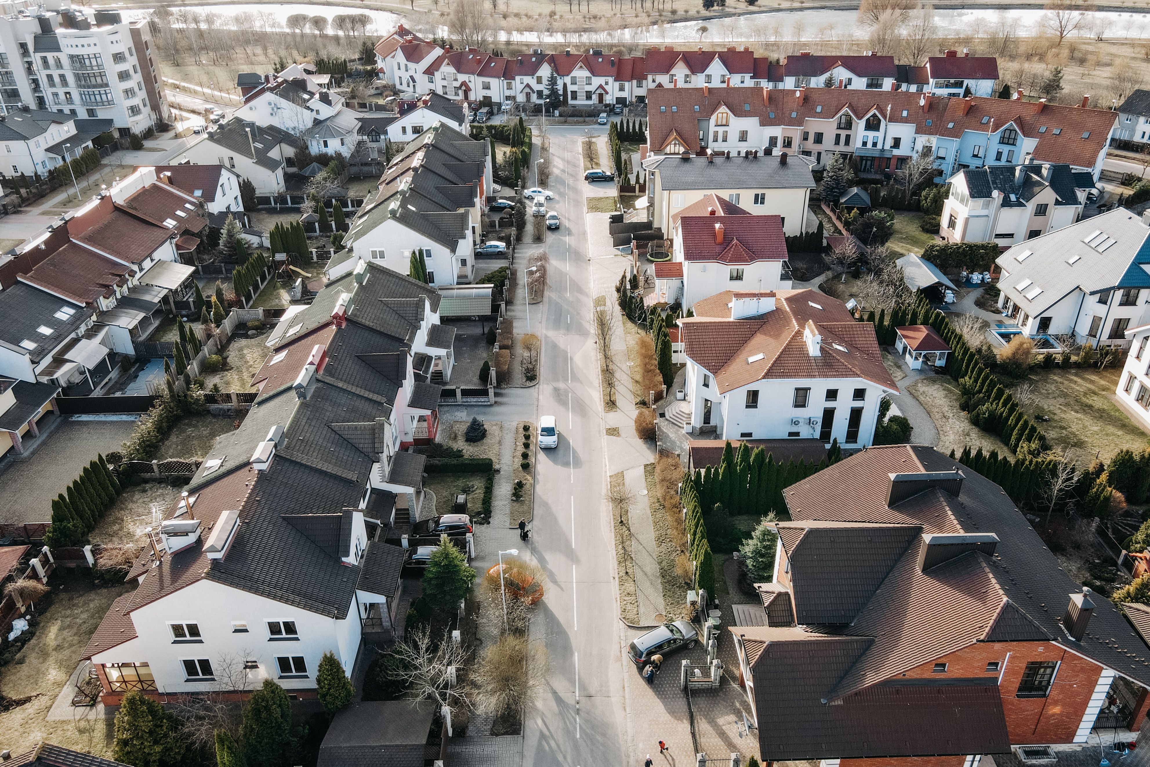 Aerial view of dense residential houses lining a city street