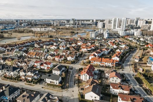Aerial perspective of suburban homes and urban high-rises, showcasing contrasting environments.