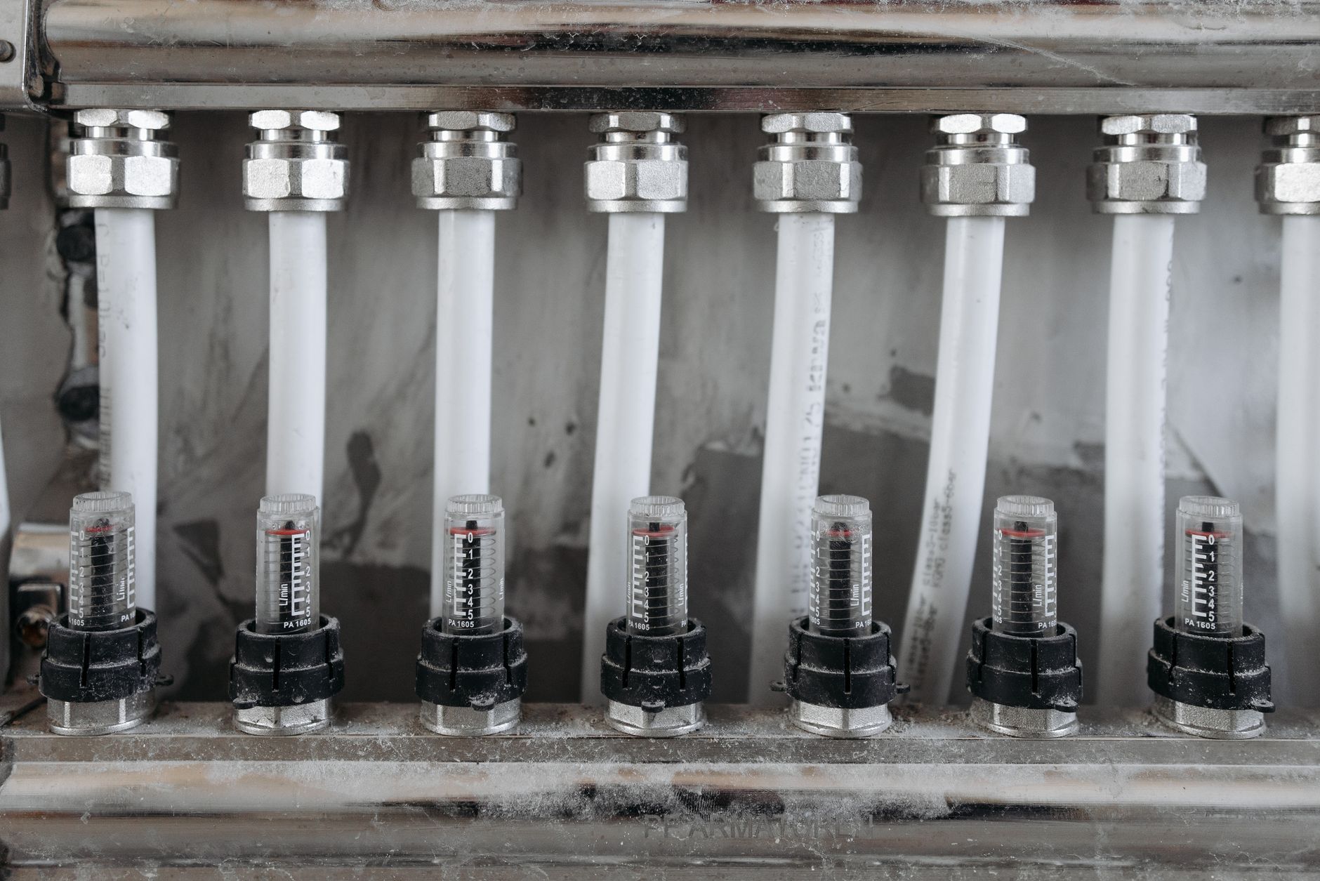 Detailed view of a network of pipes with valves in a metal framework, emphasizing industrial mechanics.