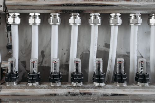 Close-up of pipes and valves during a faucet repair job