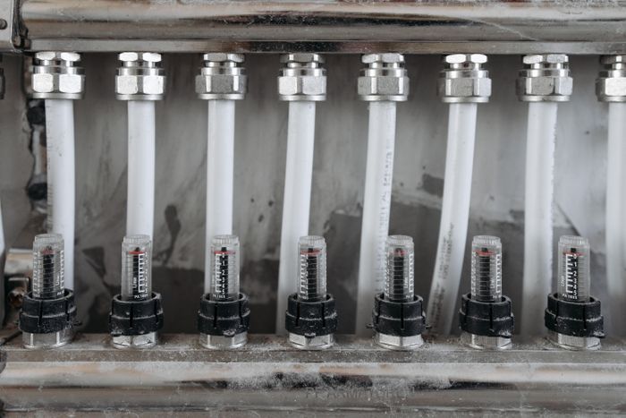 Close-up of pipes and valves during a plumbing service visit