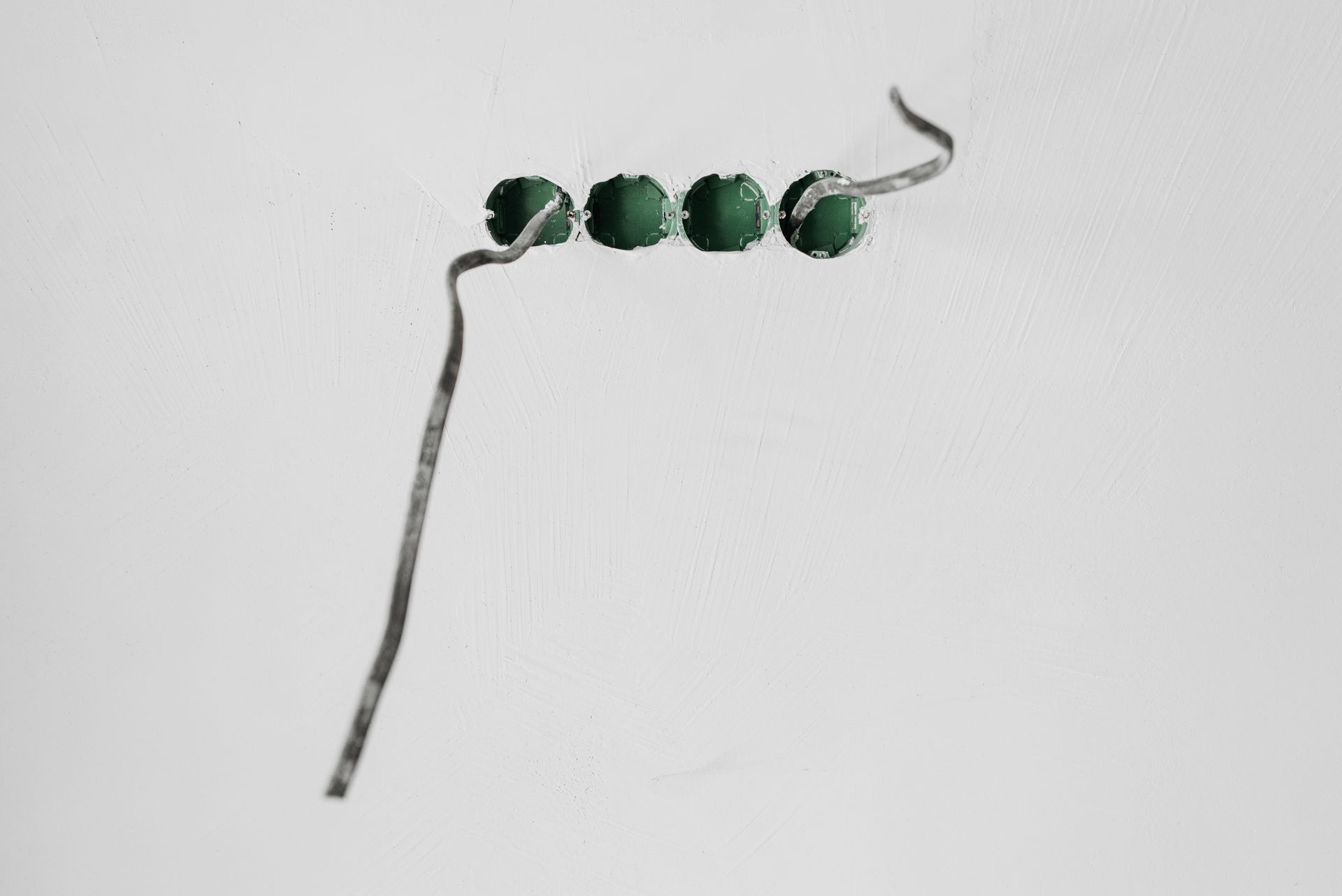 Close-up of green beads on a string against a stark white background.