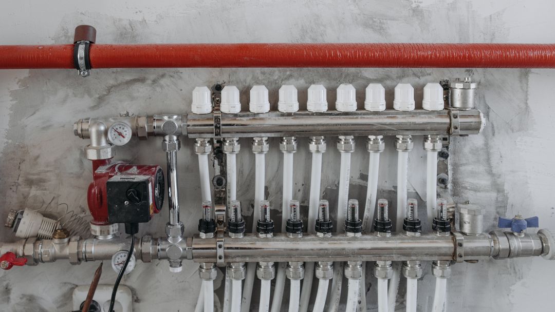 A manifold of steel pipes with individual valves and gauges